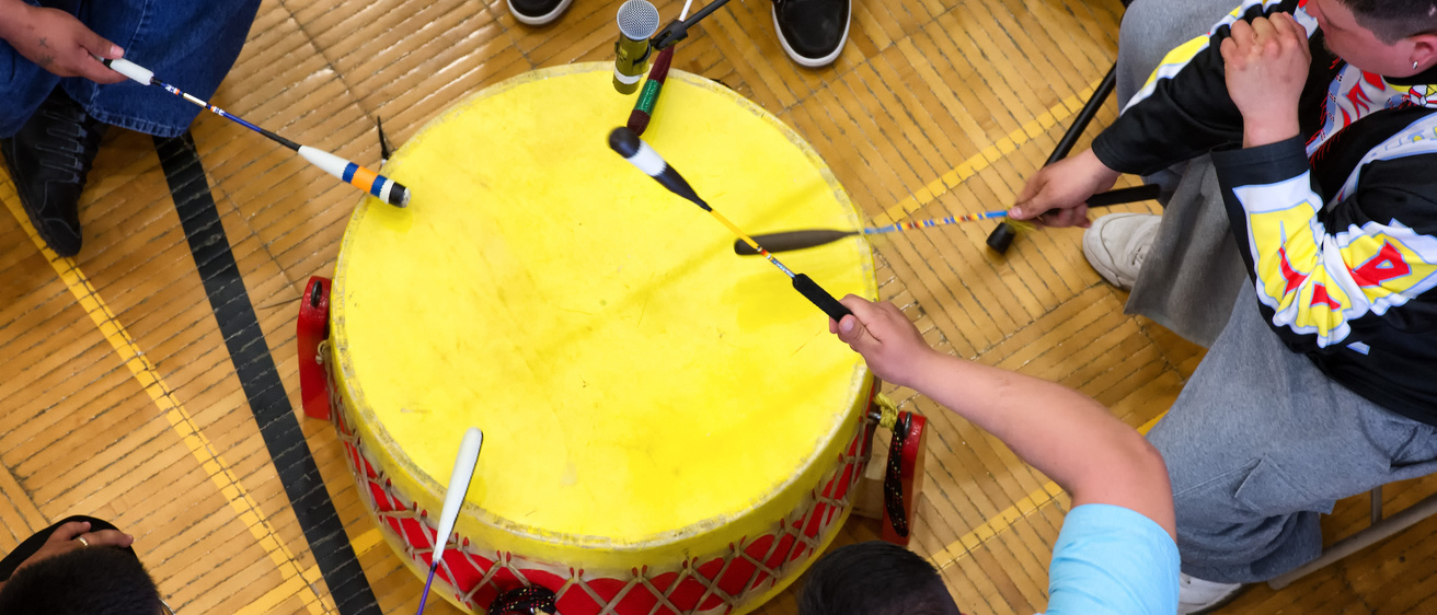 People playing a drum at the Field House